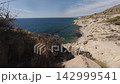 Footage shows the coastline of Costa Blanca in Benidorm with clear blue water and rocky shores 142999541
