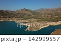 Exploring the beauty of the lake surrounded by mountains in warm daylight 142999557