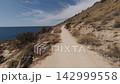 Enjoying a walk along the Costa Blanca coastline in Benidorm on a sunny day 142999558