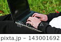 With focused effort, the hands are typing quickly, barely pausing between words. 143001692