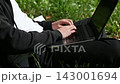 With focused effort, the hands are typing quickly, barely pausing between words. 143001694
