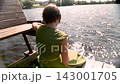 Teenage schoolgirl studying reading her books, sitting down outdoors. 143001705