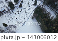Experience the serene beauty of the Church of St. Peter and Paul in Tanvald, surrounded by winter's snow-covered landscape. Aerial views showcase the peaceful scene. 143006012