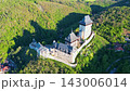 Discover the stunning Karlstejn Castle in Czechia, surrounded by lush green hills. Experience the historical architecture and breathtaking views of this medieval fortress. 143006014