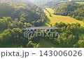 Sychrov Railway Bridge spans a lush valley in Czechia, connecting scenic landscapes and enhancing travel routes. Experience the bridge's impressive structure set against a backdrop of greenery. 143006026