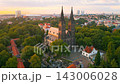Witness the breathtaking Vysehrad Basilica of St. Peter and St. Paul glowing in the early morning sky. Explore the stunning architecture surrounded by nature and the city skyline. 143006028