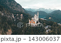 Discover the breathtaking Neuschwanstein Castle in Bavaria, Germany. The sun illuminates the stunning architecture and surrounding scenery during a peaceful morning. 143006037