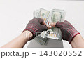 Homeless counting US dollar bills indoors 143020552