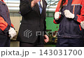The supervisor and workers joined hands to encourage each other  in the factory. 143031700