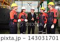 The supervisor and workers joined hands to encourage each other  in the factory. 143031701