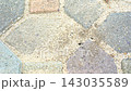 The black ants in and out of the nest under the pavement. 143035589