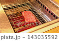 The meat is grilled on the electric grill. 143035592