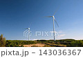 Two wind turbines generating renewable energy on a green hillside under a clear blue sky with copy space and sustainable power concept, Madeira, Portugal 143036367