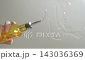 BOTTOM VIEW: Male hand pouring oil from a bottle to a cooking pan, Slow motion 143036369