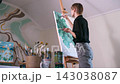 Female artist painting on easel 143038087