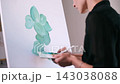 The artist paints a picture. 143038088