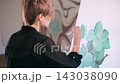 The artist paints a picture. 143038090