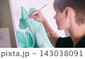The artist paints a picture. 143038091