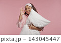 Young teen girl in pajamas holding soft pillow and showing ok okay hand sign. Relaxed morning 143045447