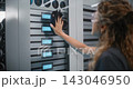 Female IT Technician Cleaning Server Rack Glass in Data Center 143046950