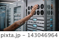 Male IT Specialist Inspecting Server Cooling Fans in Modern Data Center 143046964