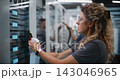 Data Center Maintenance Team Cleaning Server Racks and Vacuuming Dust 143046965
