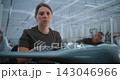 Confident Female Drone Specialist Looking at Camera in Aerospace Factory 143046966