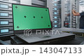 Laptop with Chroma Key Screen Beside Server Cabinets for Enterprise IT Concepts 143047133