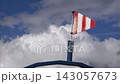 Weather flag waving on a mast under a cloudy sky at a remote location 143057673