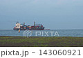 Coastal scenery and maritime landscape with container ships sailing along the shore. 143060921