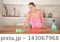 Focused young girl housewife in casual clothes cleaning table at kitchen 143067968