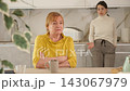 Sad mature woman arguing with her distressed daughter in kitchen 143067979