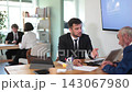 Man bank employees discussing financial documents and opening a deposit. Consultation in the bank office for an elderly client, he is interested in a savings account 143067980