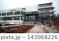 Cinema building with scaffolds and paved yard in autumn city 143068226