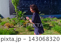 A dynamic scene showcasing a woman roller skating gracefully through a vibrant outdoor setting adorned with lush greenery and artistic murals, exuding energy and joy. 143068320