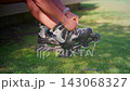 Exciting Moments of Roller Skating: The Journey from Tying Shoes to Gliding Over Grass in a Beautiful Outdoor Setting 143068327