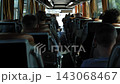Passengers traveling inside a bus, enjoying the journey view from the aisle 143068467
