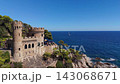 Aerial view of the coastline of Lloret de Mar, Costa Brava, Spain, filmed with a drone - the sea, beach, and castle on the coastal cliffs of the city bay on a sunny day 143068671