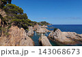 An aerial view of a drone flies over the beach, sea and coastal cliffs near Santa Clotilde Park on a sunny day in the tourist town of Lloret de Mar, Catalonia, Spain 143068673