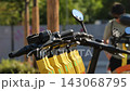 Electric scooters parked in urban setting providing sustainable city transportation 143068795