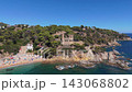 Aerial view of the coastline of Lloret de Mar, Costa Brava, Spain, filmed with a drone - the sea, beach, and castle on the coastal cliffs of the city bay on a sunny day 143068802