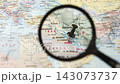 Magnifying glass highlights Kuwait on printed map 143073737