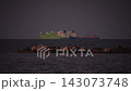 Ships on the horizon in calm waters at dusk 143073748