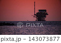 Oil platform silhouette against sunset background 143073877
