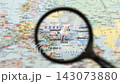 Magnifying glass reveals marked location on map 143073880