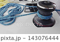 marine winch and ropes of sailing boat in the rain, rotation, yachtsman hands, sailor 143076444