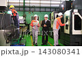 A supervisor walks around the factory with subordinates to inspect the quality of the work. 143080341