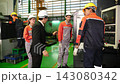 A supervisor walks around the factory with subordinates to inspect the quality of the work. 143080342