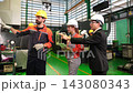 A supervisor walks around the factory with subordinates to inspect the quality of the work. 143080343
