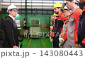 The manager gave a training speech to the workers before they started working in the factory. 143080443